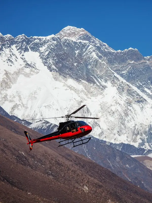 red helicopter and snow mountains