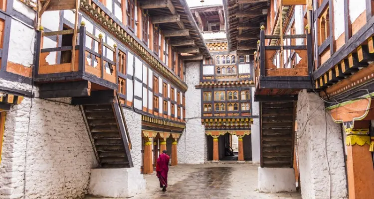a monk in red in Jakar Dzong